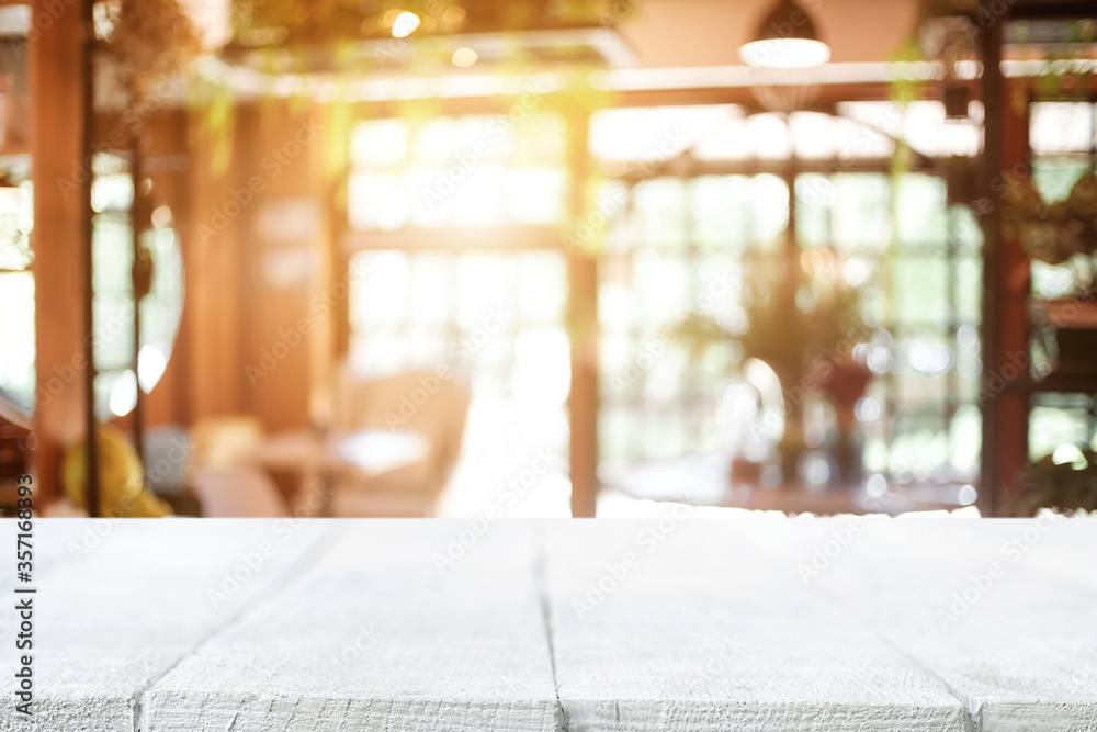 Empty wooden table space platform and blurred restaurant or coffee shop background for product display montage.