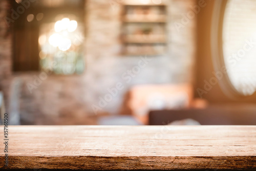 Empty wooden desk space platform and blurred resturant or coffee shop background for product display montage.