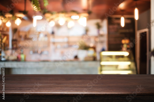 Empty wooden table space platform and blurred resturant or coffee shop background for product display montage.