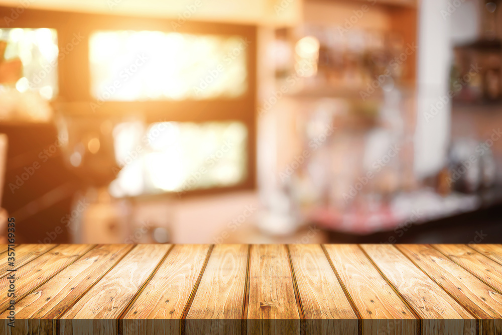 Empty wooden table space platform and blurred restaurant or coffee shop background for product display montage. Empty wooden table space platform and blurred restaurant or coffee shop background for product display montage.