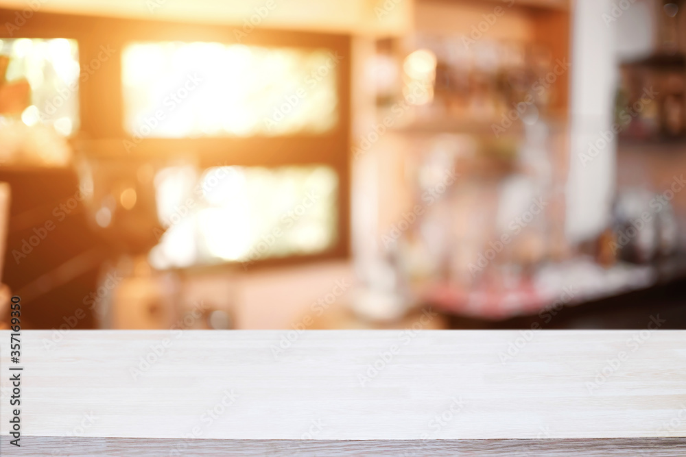 Empty wooden table space platform and blurred restaurant or coffee shop background for product display montage.