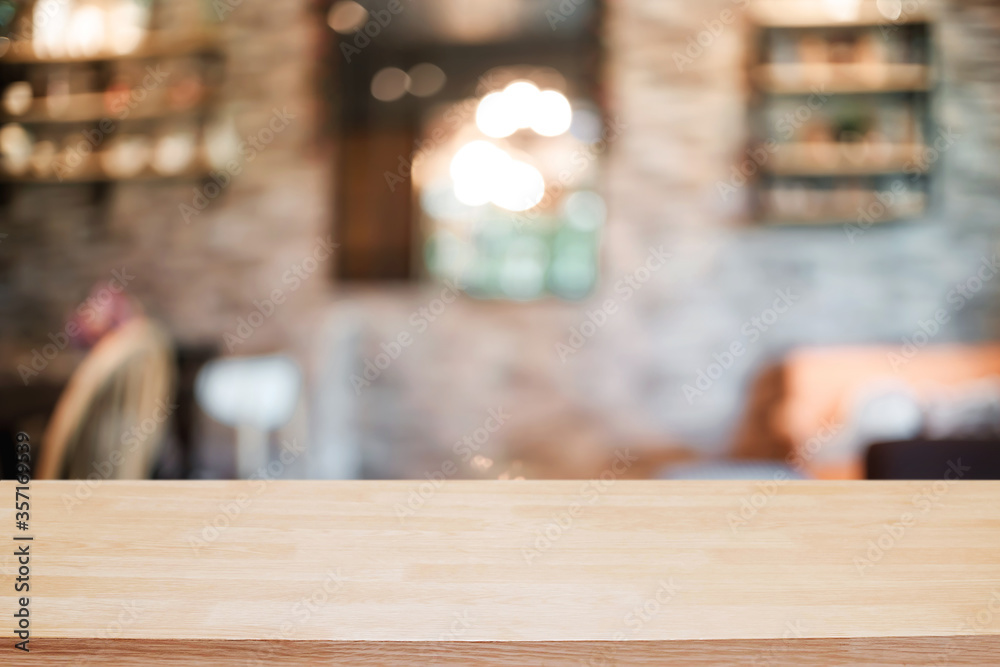 Empty wooden table space platform and blurred resturant or coffee shop background for product display montage. Empty wooden table space platform and blurred resturant or coffee shop background for product display montage.