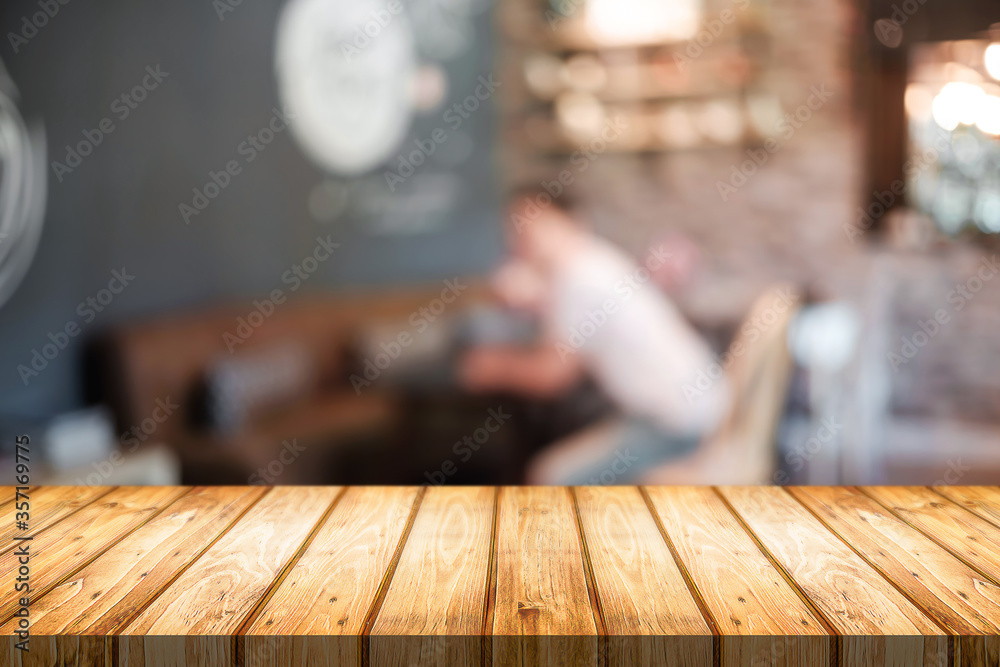 Empty wooden table space platform and blurred restaurant or coffee shop background for product display montage. Empty wooden table space platform and blurred restaurant or coffee shop background for product display montage.