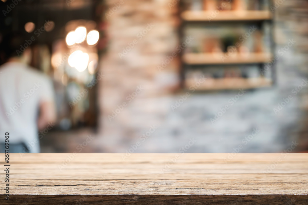 Empty wooden table space platform and blurred resturant or coffee shop background for product display montage. Empty wooden table space platform and blurred resturant or coffee shop background for product display montage.