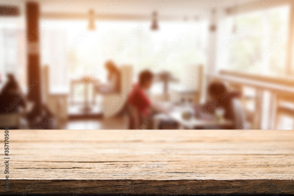 Empty wooden table space platform and blurred resturant or coffee shop background for product display montage. Empty wooden table space platform and blurred resturant or coffee shop background for product display montage.