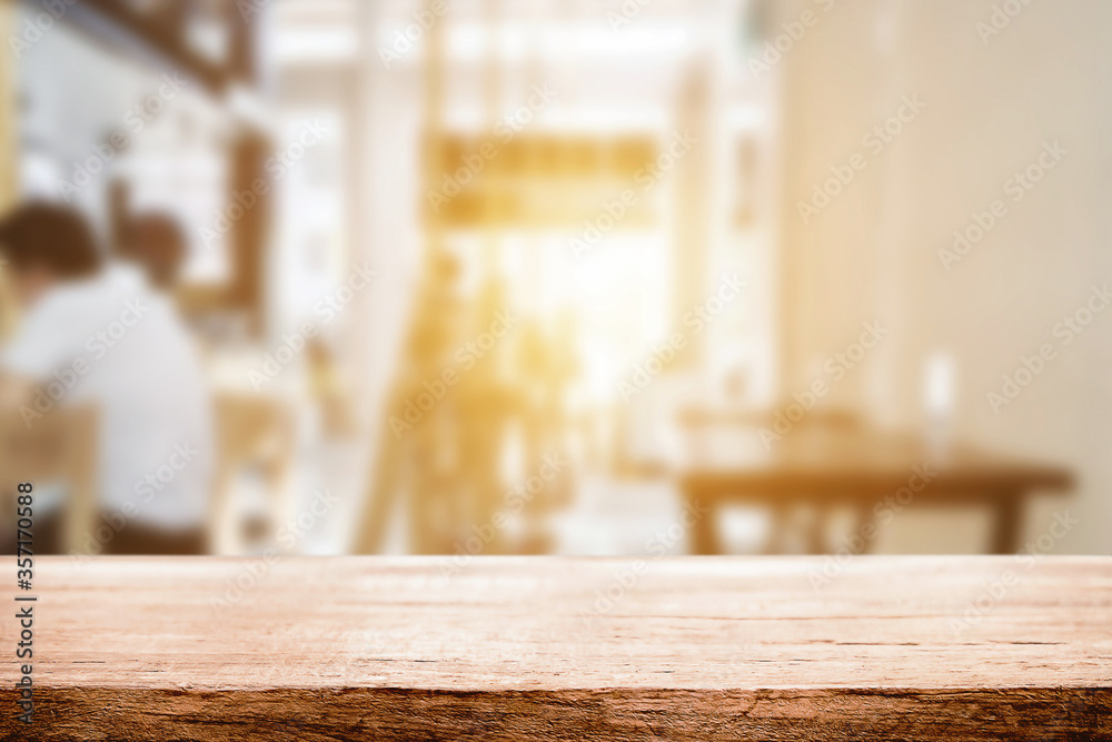 Empty wooden table space platform and blurred resturant or coffee shop background for product display montage. Empty wooden table space platform and blurred resturant or coffee shop background for product display montage.