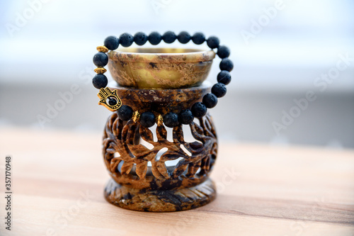 Cool design black bracelet with hamsa hand symbol. photo