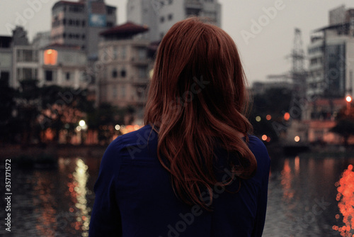 young woman looking at the river
