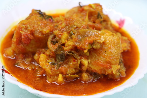 Dum aloo, potatoes in thick onion  tomato gravy  photo