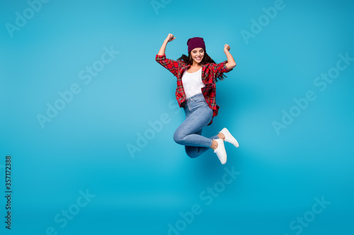 Full length body size view of her she nice attractive lovely pretty cheerful cheery lucky girl jumping having fun rejoicing isolated over bright vivid shine vibrant blue color background