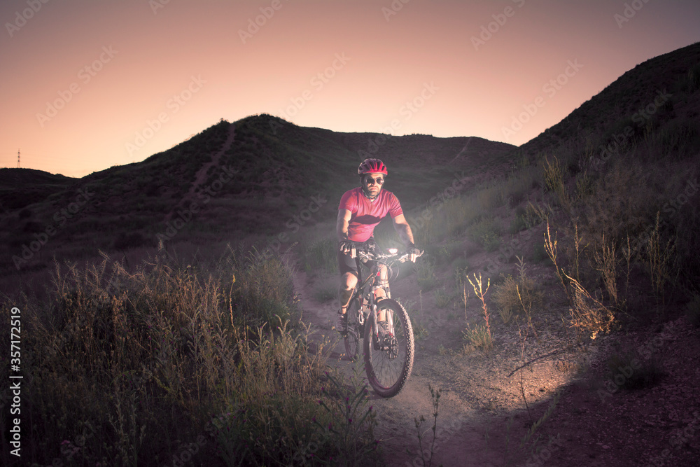man riding a mountain bike at dusk man riding a mountain bike at dusk