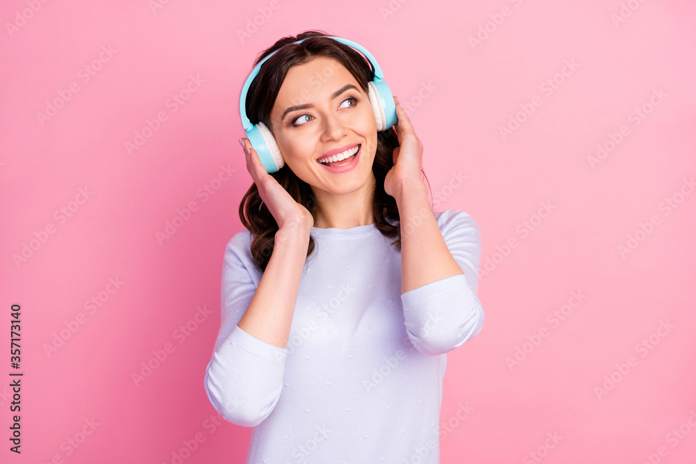 Photo of beautiful cheerful lady cool modern technology headphones enjoy youth music song look interested empty space inspired wear casual white shirt isolated pink color background Photo of beautiful cheerful lady cool modern technology headphones enjoy youth music song look interested empty space inspired wear casual white shirt isolated pink color background