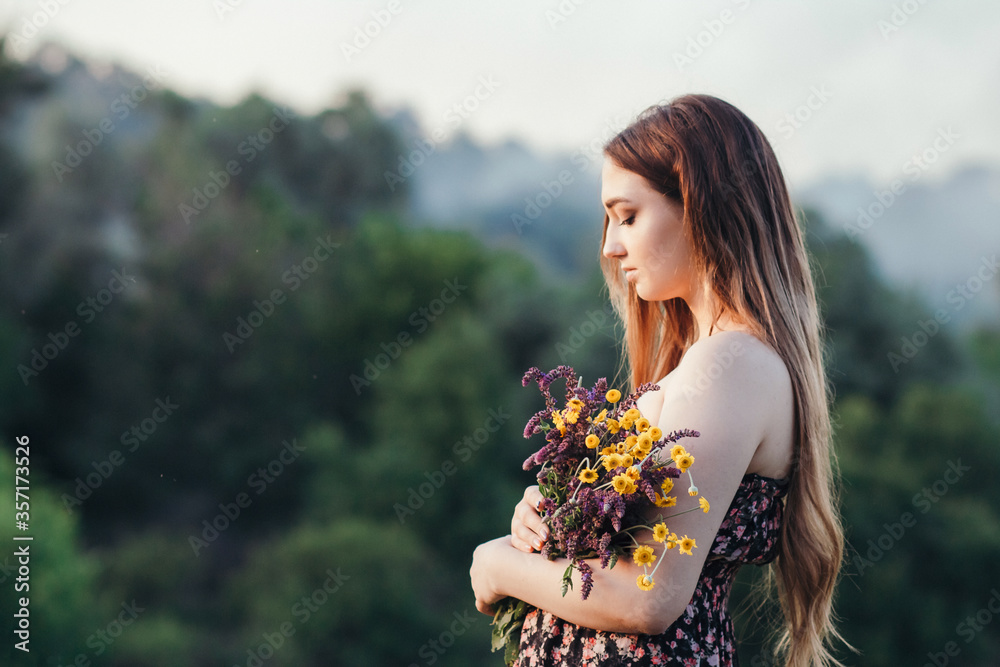 beautiful girl with bouquet of wildflowers on meadow, young woman with long hair in dress walking on nature,summer tender photo in village beautiful girl with bouquet of wildflowers on meadow, young woman with long hair in dress walking on nature,summer tender photo in village