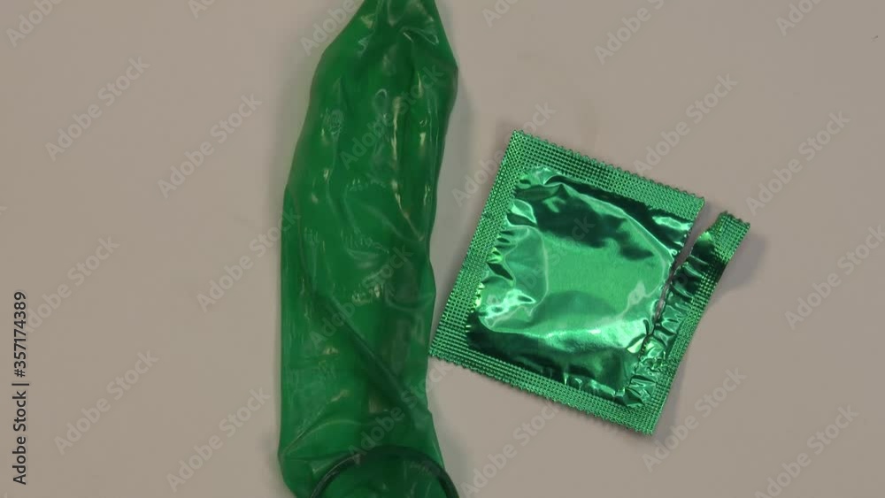 Display of colored condom arranged neatly on a rotating platform