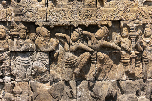 Depictions of mythological scenes from the life of Buddha, or related, in the form of reliefs and decorative motifs carved in stone, in the temple of Borobudur, Indonesia. photo