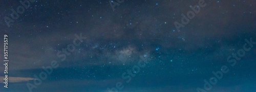 Amazing Panorama blue night sky milky way and star on dark background.Universe filled with star, nebula and galaxy with noise and grain.Photo by long exposure and select white balance.selection focus.