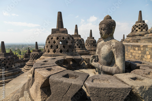 Representation of the exposed Buddha, Dharmachakra mudra, reaching Nirvana, on top of the Borobudur temple in Central Java, Indonesia, near the central stupa.