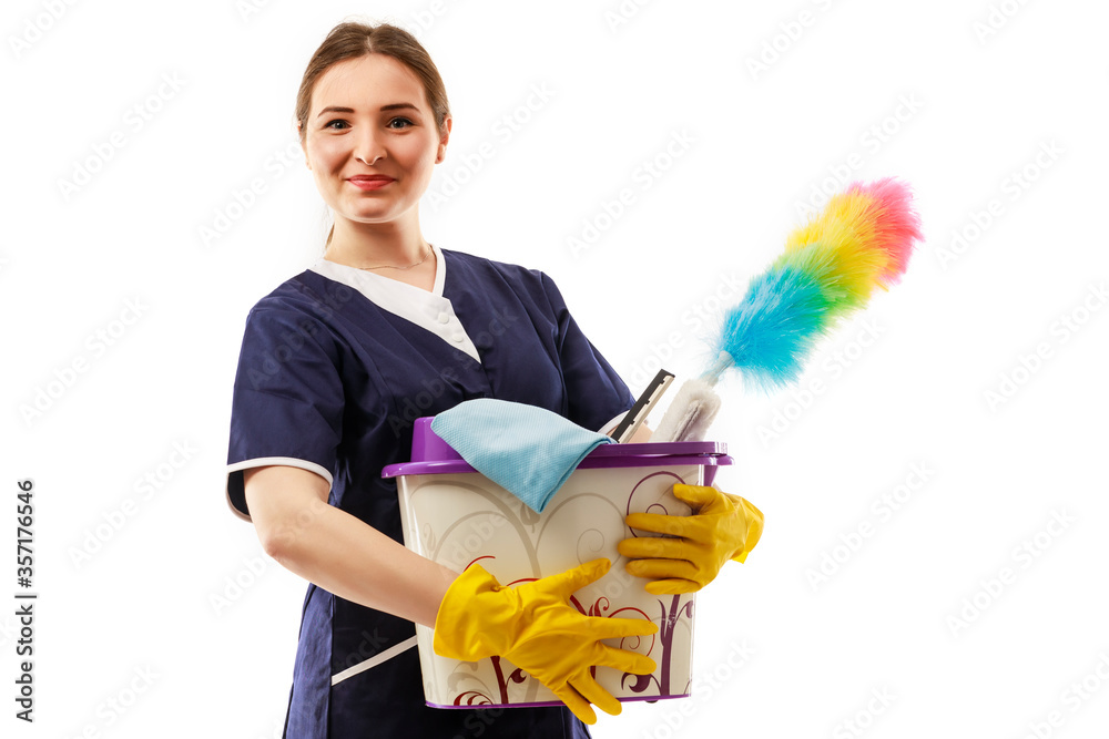 Cleaning concept. Young woman holds basin with washing fluids and rags in hands Cleaning concept. Young woman holds basin with washing fluids and rags in hands