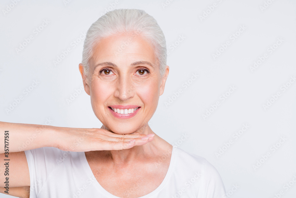 Close-up portrait of her she nice-looking attractive lovely cheerful cheery positive healthy shine gray-haired lady demonstrating perfect elastic flawless skin isolated on light white grey background Close-up portrait of her she nice-looking attractive lovely cheerful cheery positive healthy shine gray-haired lady demonstrating perfect elastic flawless skin isolated on light white grey background