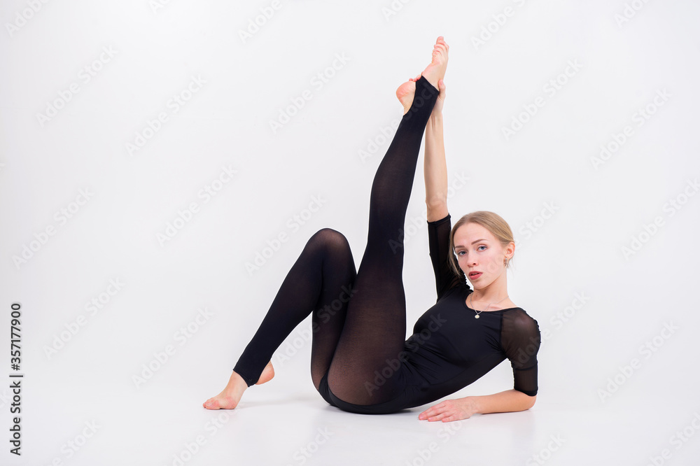beautiful young woman with fair hair gymnastics training calilisthenics exercise on white studio background. beautiful young woman with fair hair gymnastics training calilisthenics exercise on white studio background.