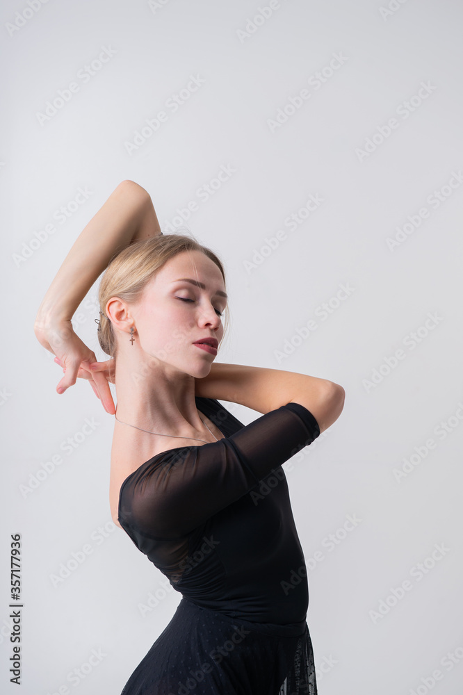 Portrait of slim young female gymnast with pale skintraining calilisthenics exercise on a white studio background Portrait of slim young female gymnast with pale skintraining calilisthenics exercise on a white studio background