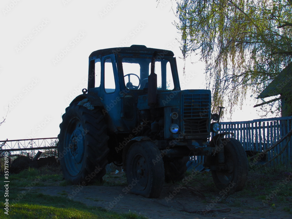 Old tractor near the field. Old tractor near the field.