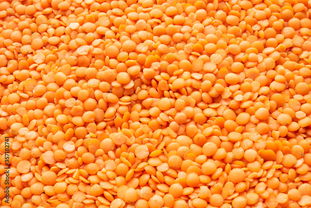 Red lentils background. Focus all over the frame.