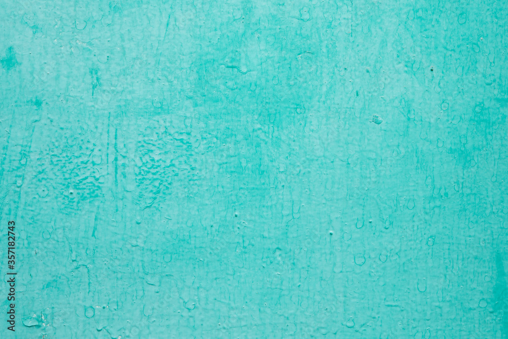 Texture concrete wall with sheltered blue and green paint closeup