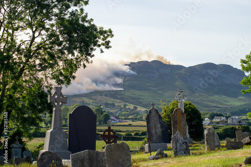 old grave yard and wild fire in The Cooley mountains Lordship county Louth Ireland