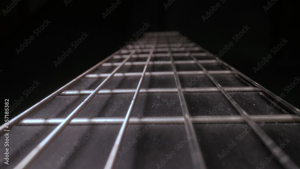 Acoustic guitar fretboard macro closeup slider shot