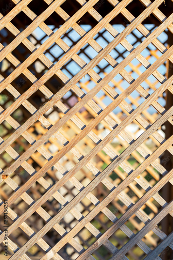 Wooden planks for background on a diagonal. White Lattice with Wooden Background Wooden planks for background on a diagonal. White Lattice with Wooden Background