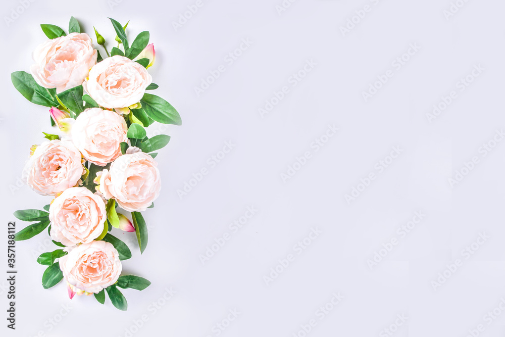 Floral peonies arrangement . Artificial tender white pinkish peony flower with leaves, flat composition on a light background. top view place for text