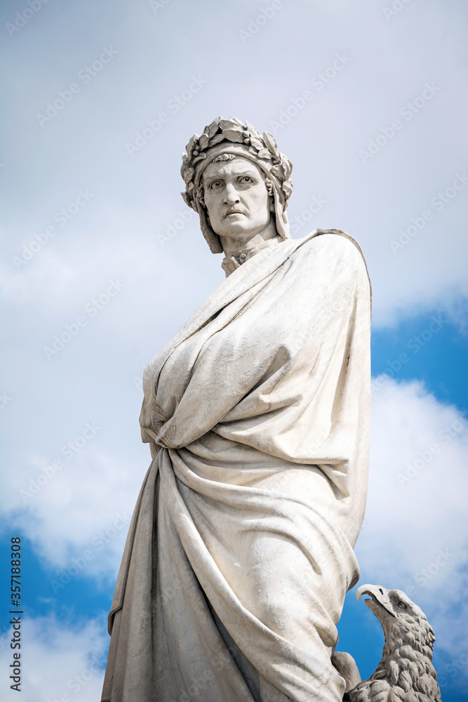 Statue of Dante Alighieri in Piazza di Santa Croce with cloudy sky background. Florence, Italy. Statue of Dante Alighieri in Piazza di Santa Croce with cloudy sky background. Florence, Italy.