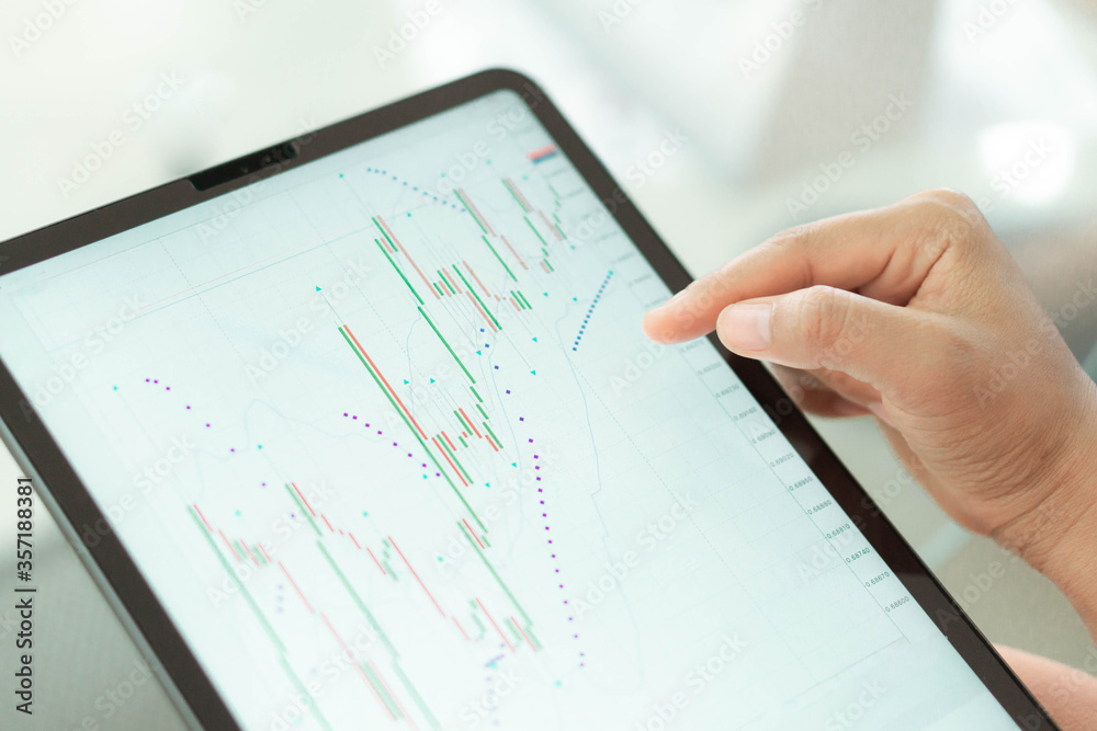 Business woman hand holding digital tablet computer with graph of Binary option for trading platform, setective focus Business woman hand holding digital tablet computer with graph of Binary option for trading platform, setective focus