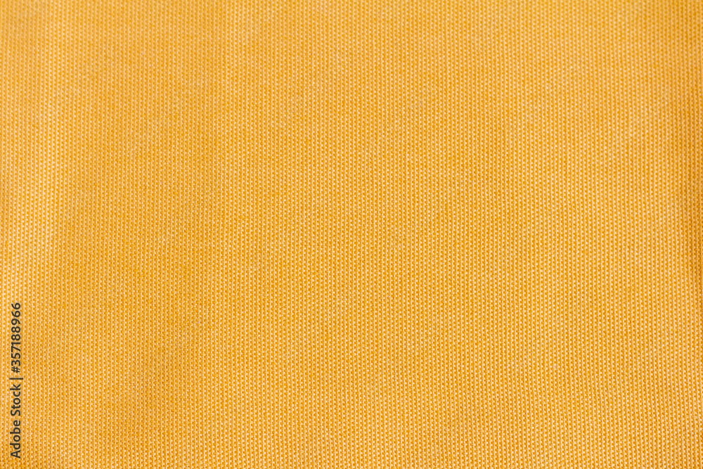 Fotka „Dense cotton fabric texture of yellow or mustard color.Fabric