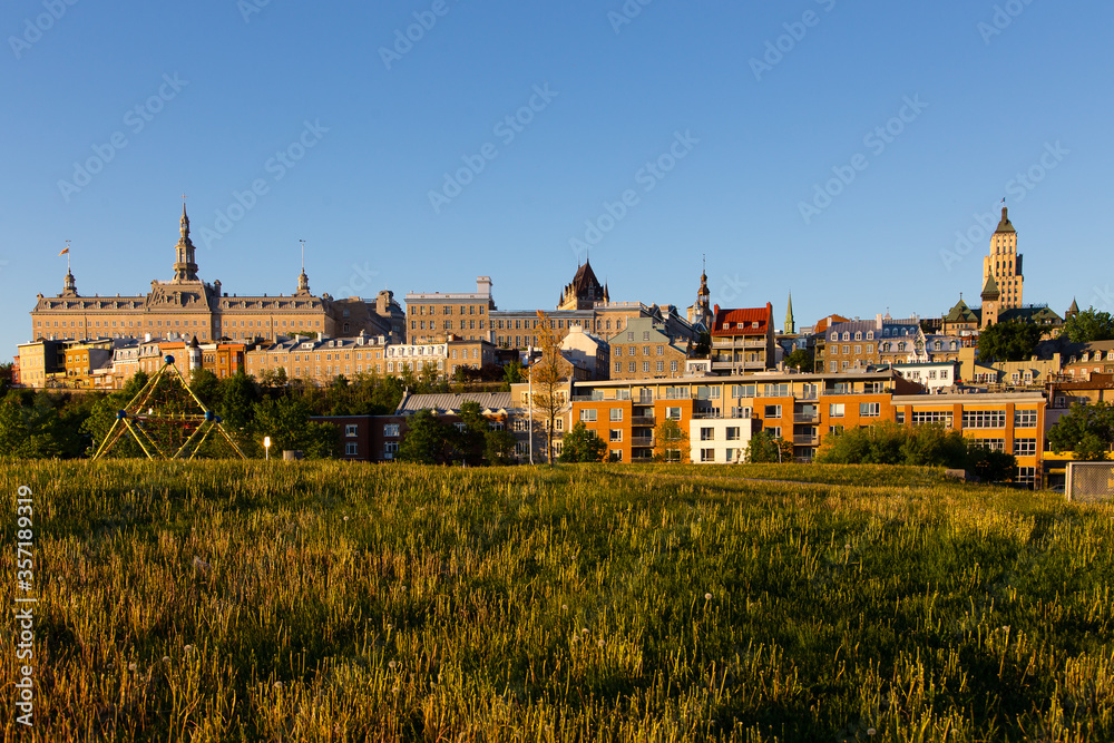 Patrimonial buildings and houses in the upper and lower town along the Remparts and St. Paul streets seen from the old port park during a sunny spring dawn, Quebec City, Quebec, Canada 