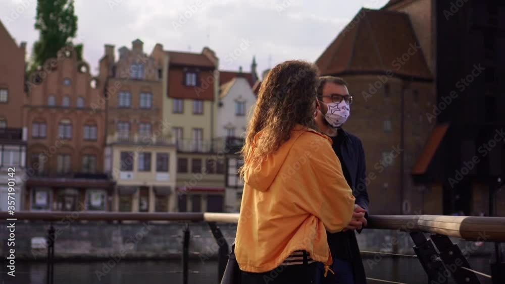 Young Couple Enjoying a Beautiful Day During Coronavirus Pandemic, Faces Covered with Protective Masks Young Couple Enjoying a Beautiful Day During Coronavirus Pandemic, Faces Covered with Protective Masks