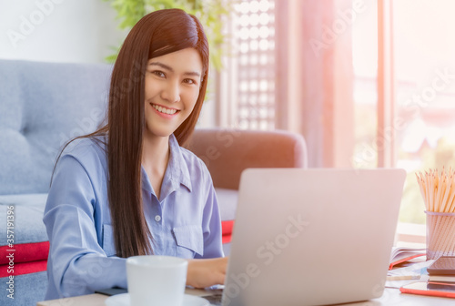 Beautiful asian businesswoman working from home.