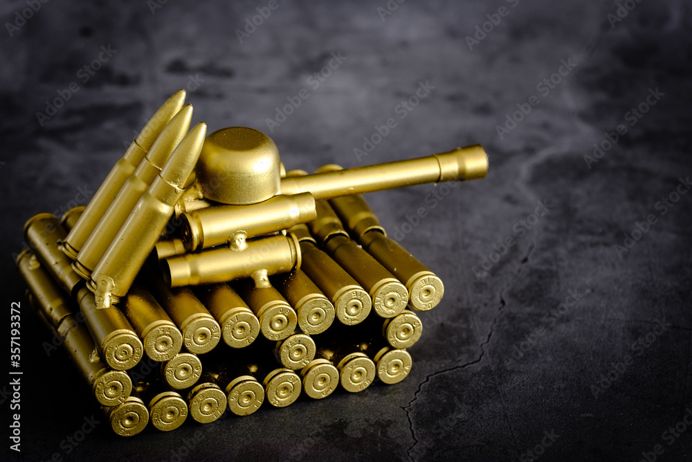 bullet shell toy tank on a black background closeup view bullet shell toy tank on a black background closeup view