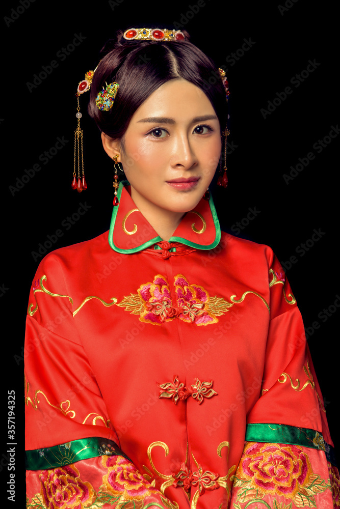 Girl wearing ancient Asian bride dress in black background Girl wearing ancient Asian bride dress in black background