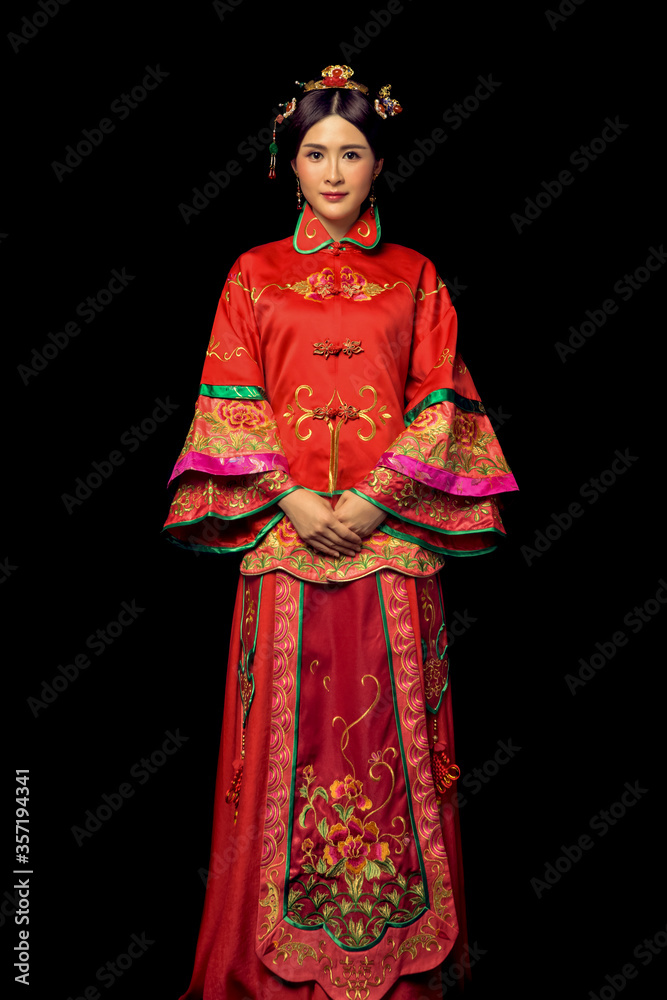 Girl wearing ancient Asian bride dress in black background Girl wearing ancient Asian bride dress in black background