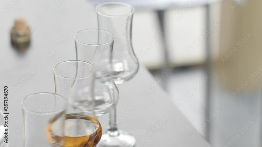 Whiskey in glasses on a thin leg. Cocktail party whiskey tasting Whiskey in glasses on a thin leg. Cocktail party whiskey tasting