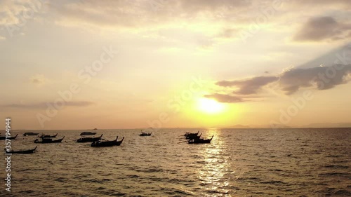 Aerial view, flying over the sea at sunset time. Fishermen boats mouring. Drone dji mavic air 4K 30fps photo