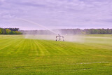 Farmers irrigate fields because of the drought, crops waiting for the rain to come. Drenthe, the Netherlands.