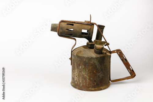 Old rusty blowtorch isolated on a white background photo