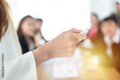 close up hand, hand holding laser pen and  point to information board, presenter and team discuss about strategy plan and knowledge sharing