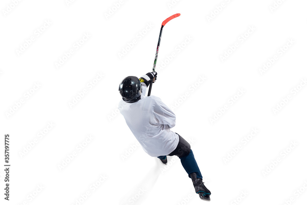 Fototapeta premium Unrecognizable male hockey player with the stick on ice court and white background. Sportsman wearing equipment and helmet practicing. Concept of sport, healthy lifestyle, motion, action. Top view.