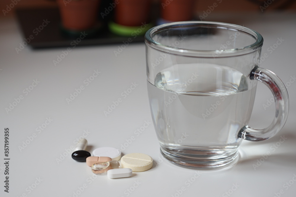 glass of water and pills glass of water and pills