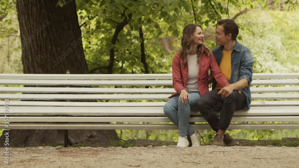 Young, happy, loving couple having date in the park. Relations, friendship and love concept. Young, happy, loving couple having date in the park. Relations, friendship and love concept.