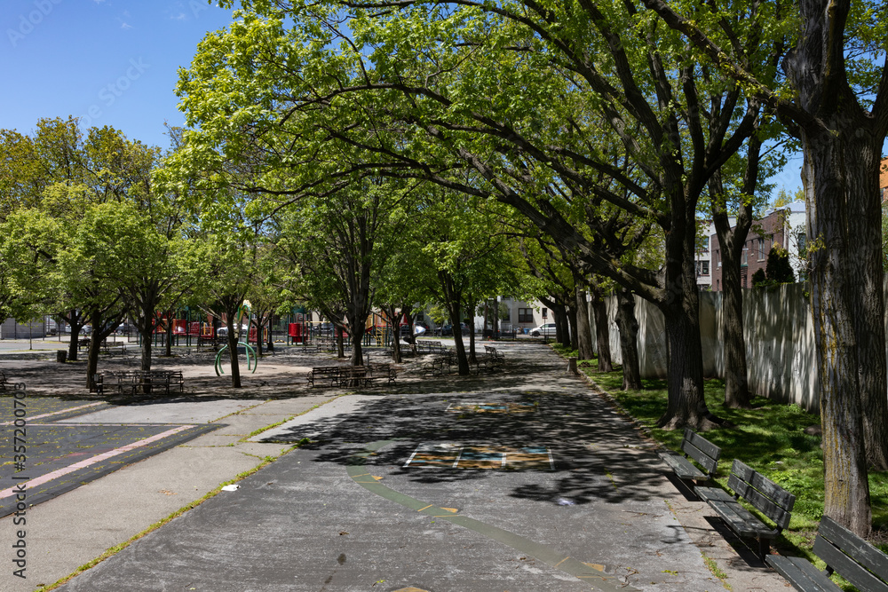 Empty Hoyt Playground with Green Trees during Spring in Astoria Queens New York Empty Hoyt Playground with Green Trees during Spring in Astoria Queens New York